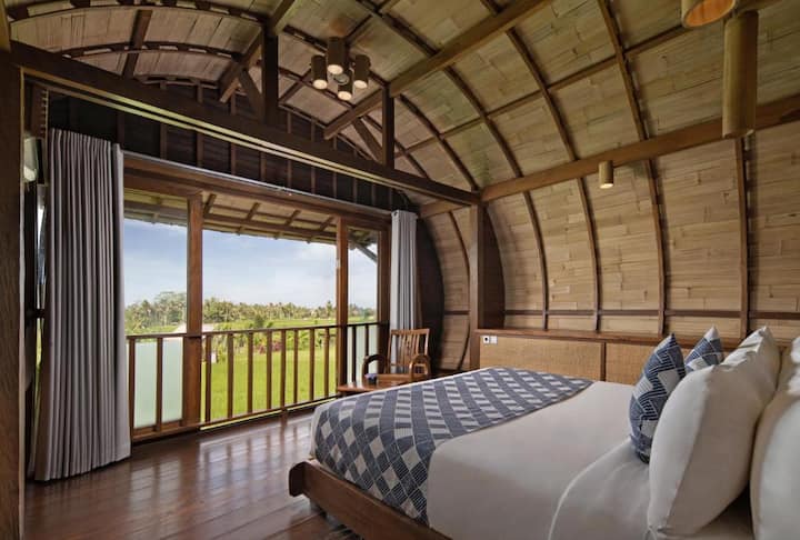 cylindrical villa surrounded by rice farms; kecamatan ubud, bali