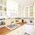 Wood floors, wood butcher block counter tops, a petite farmhouse sink, and cute cabinet knobs