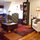 Living room. The television is covered by the African fabric, and the aerobed rests beside it.