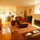 Living room  - front door is behind big chair.   Also dining room in background. 