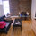 Livingroom with couch/futon, flat screen tv, dresser wth room for clothes and kitchen table for 4. 