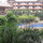 Balcony view of lush foregarden, poolside and club house...