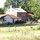 Back of the house.  Look closely and you can see Sam!  (Big black dog in the yard.)