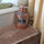 An antique copper lantern from Italy sits on the wicker trunk where extra blankets can be found.
