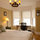 Queen-sized bed with desk in bright sunny bedroom. 