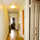 Main hallway from opposite direction, with the front door to apartment up ahead. 