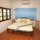 The King size bed with Euro/Western quality pillow-top mattress, high-thread count Egyptian cotton linens and blackout curtains.