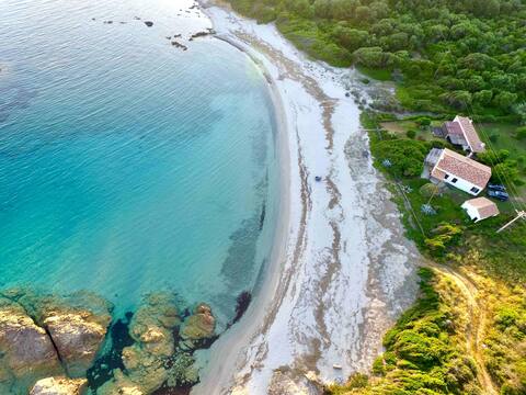 House  in a cove, on a sandy beach