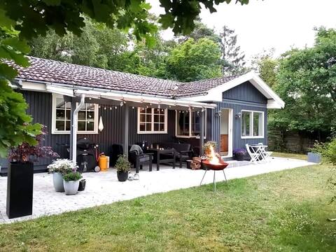 Cottage by forest, beach and town