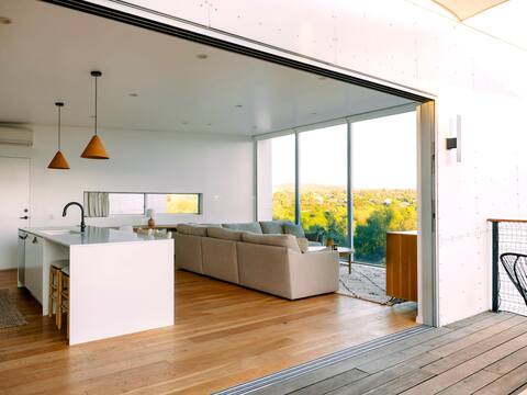 A modern light-filled home with views of the woods