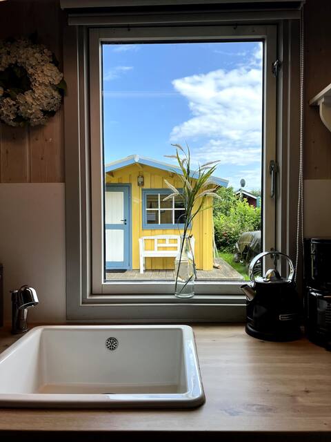 The small yellow vacation home
