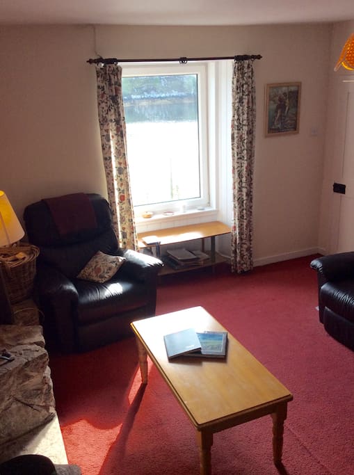 Lounge with sea views and an open fire.