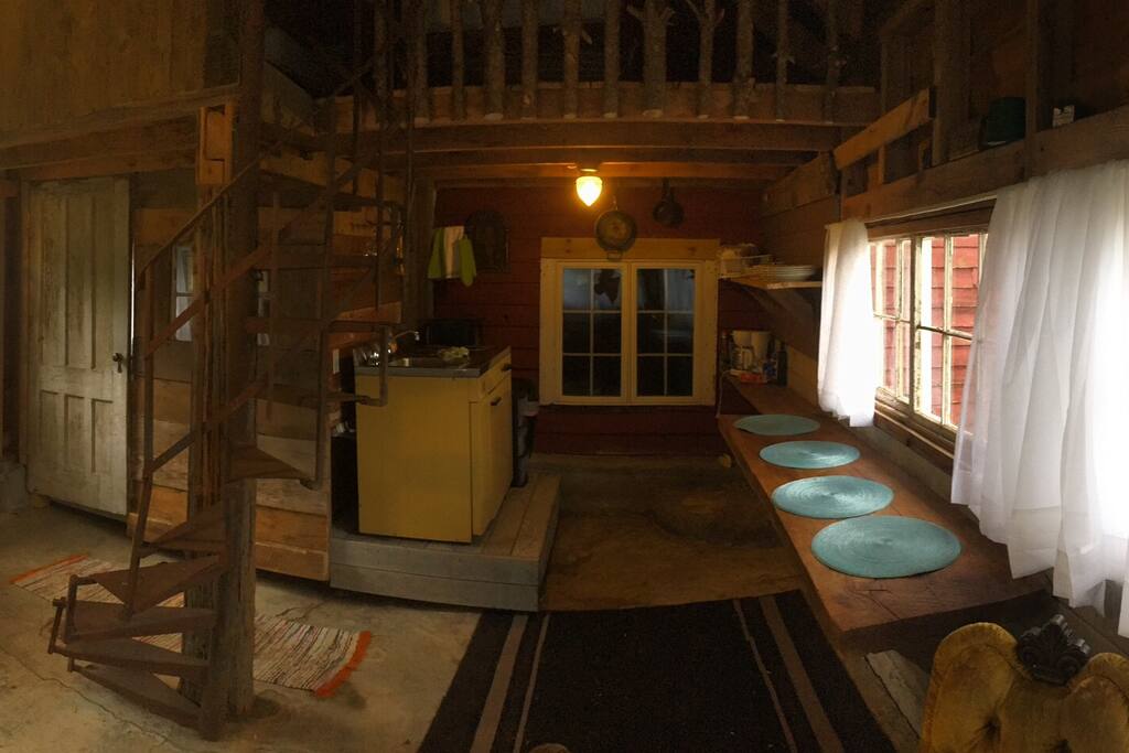 Narrow spiral staircase leads to twinning twin beds; kitchenette.