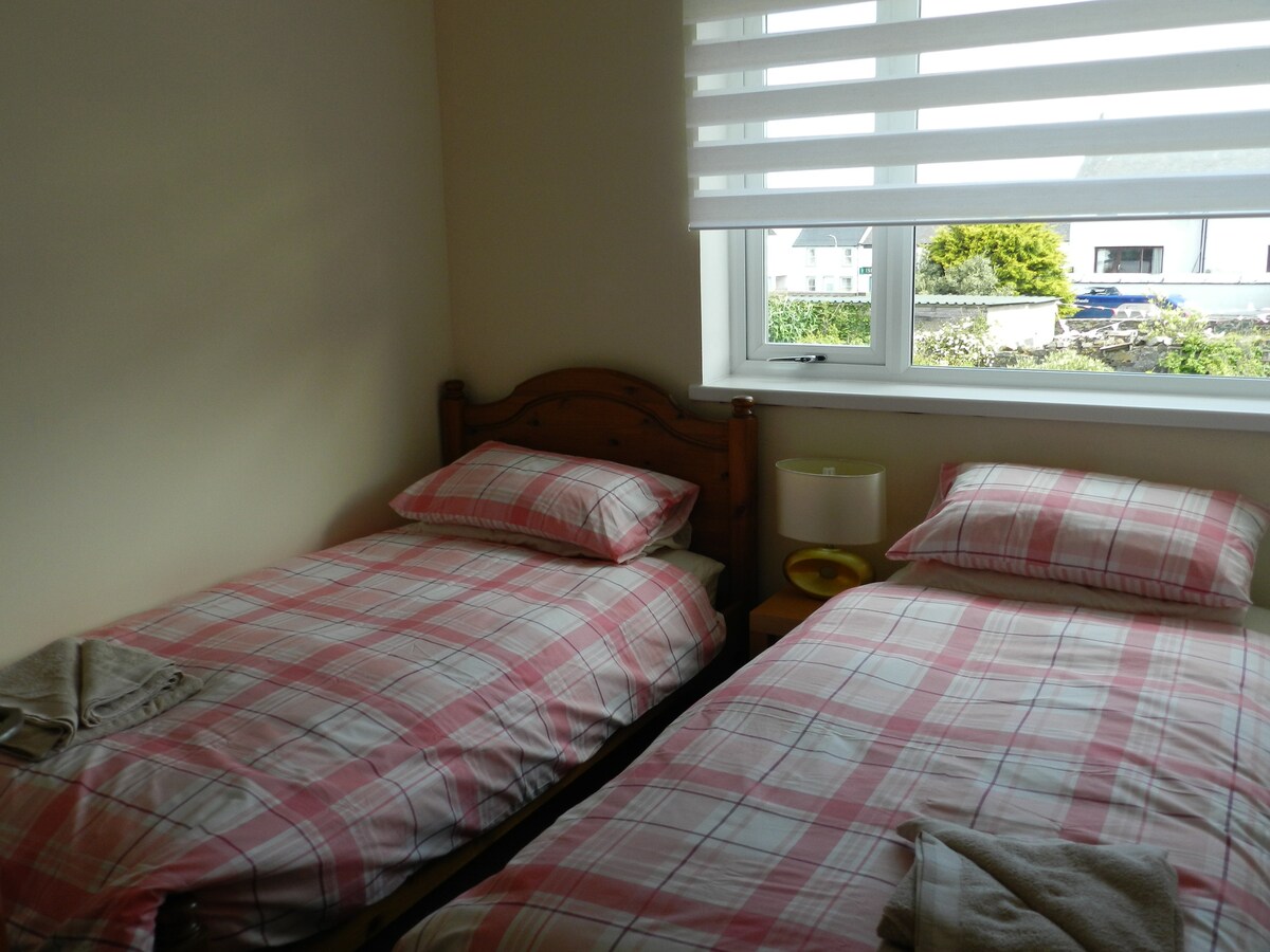 Bedroom 3 is a twin bedroom with built in wardrobe and views overlooking the garden and loch.