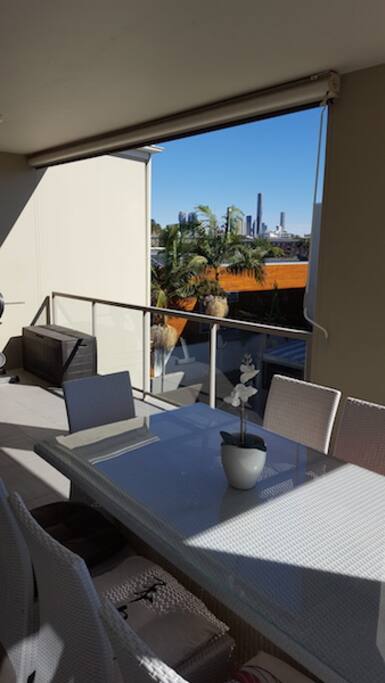 Balcony with a city view over the pool.