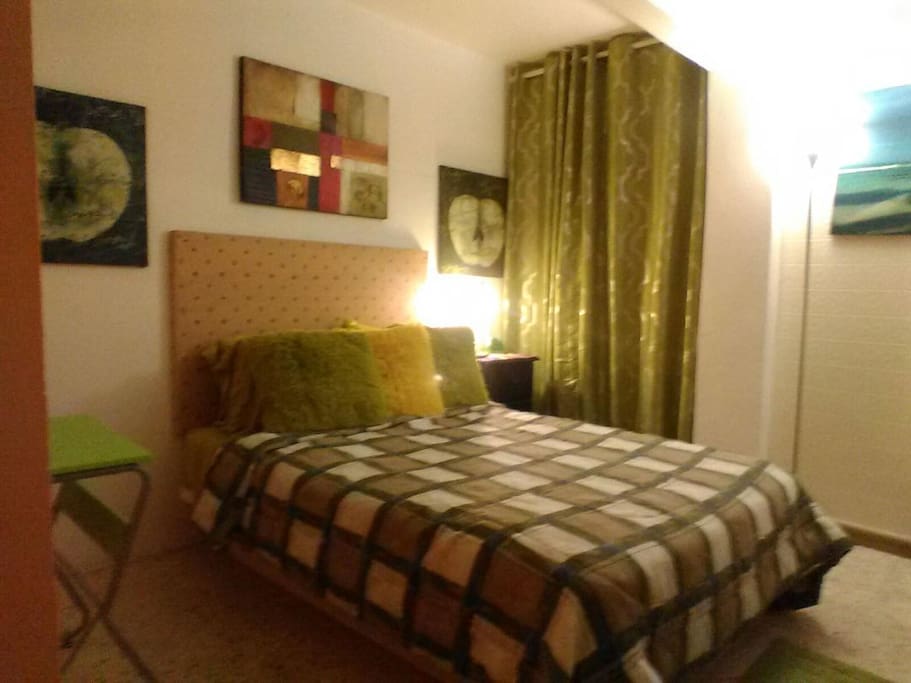 Full size bed inside mini studio sleeps 2 in total privacy, night table, closet, lamp, small desk.