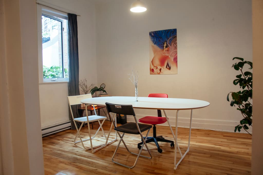 brightly lit dining area/workspace