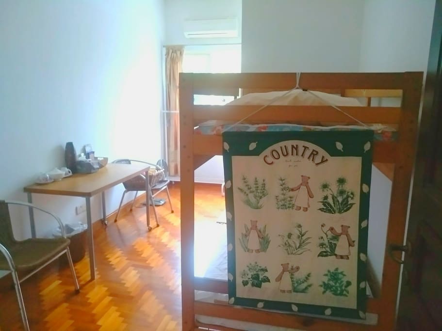 Comfortable bunk bed with table and 2 arm chairs
