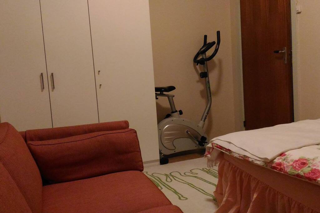 The room has a wardrobe and a hanger behind the door.