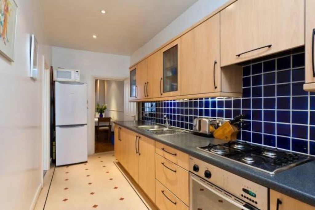Large galley style kitchen with plenty of storage and space to cook