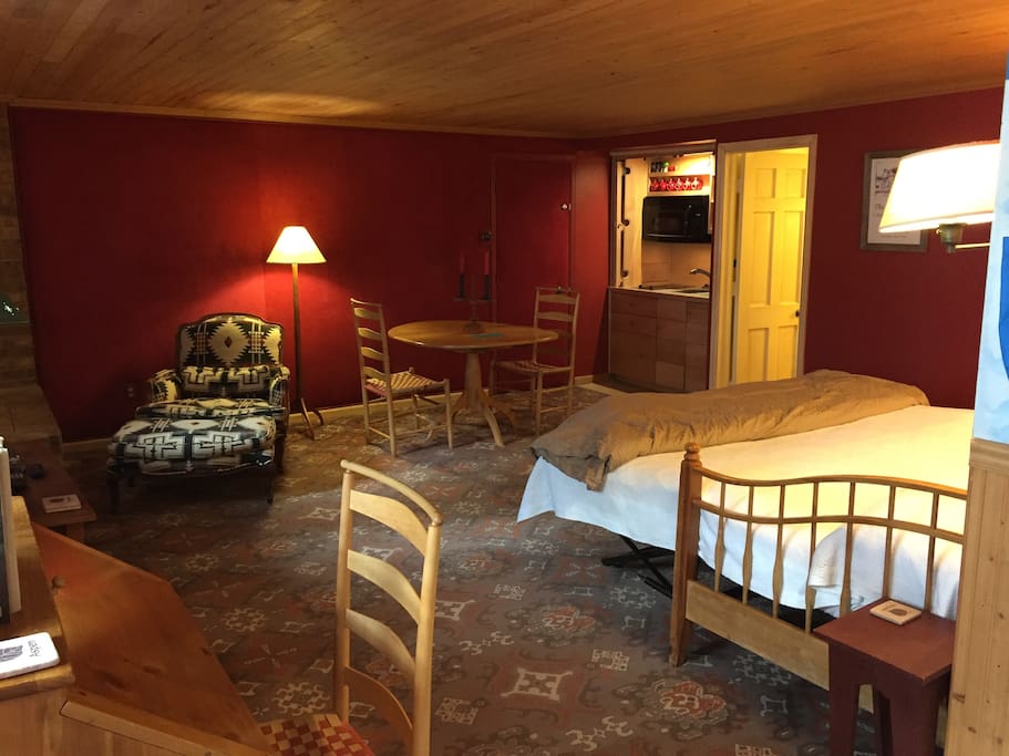 view from the foyer showing the king bed and the armoire kitchen