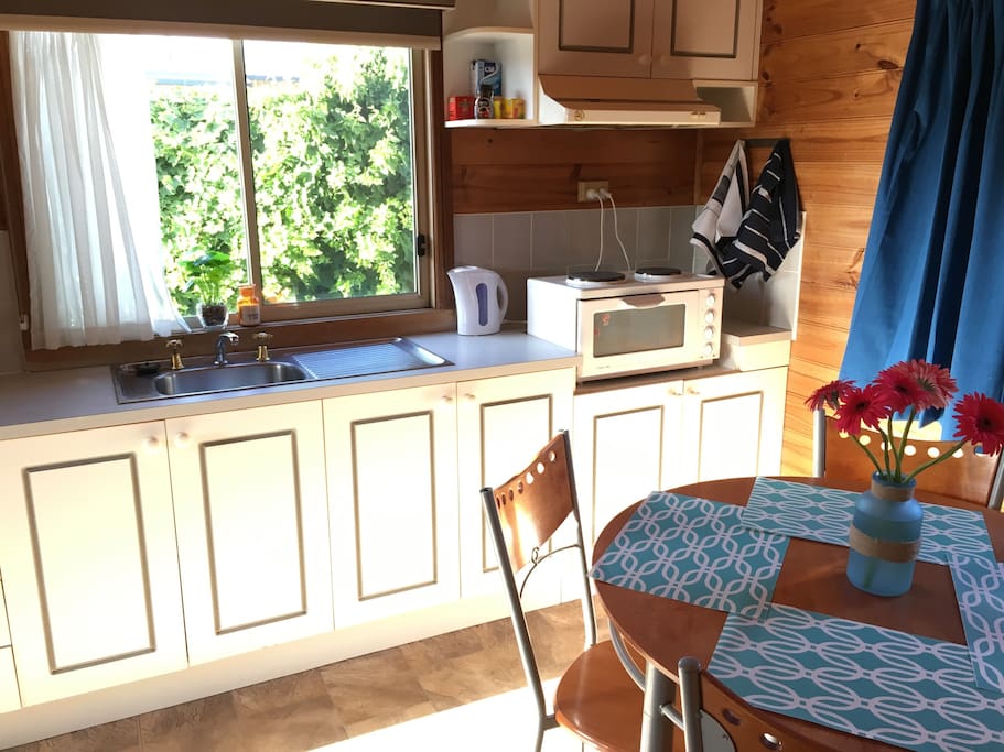 Mini oven, two stove tops, microwave, kettle and bar fridge. Cutlery and utensils provided.