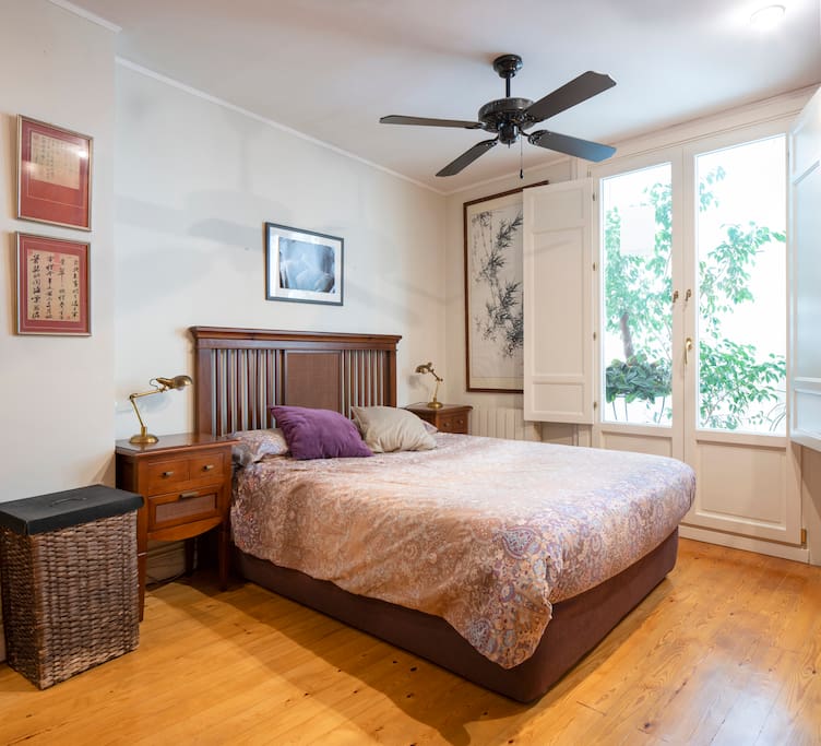 Double bed with balcony and fan
