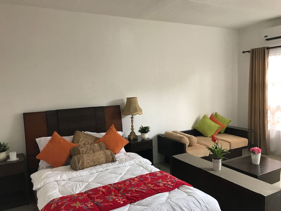 Our room is equipped with a double sized bed good for 2 guests, fresh linens, a comforter, pillows. a 2 seater sofa, a TV and cable TV, and Carrier Air conditioning system. A floor mattress can be added for another guest or an extra person.