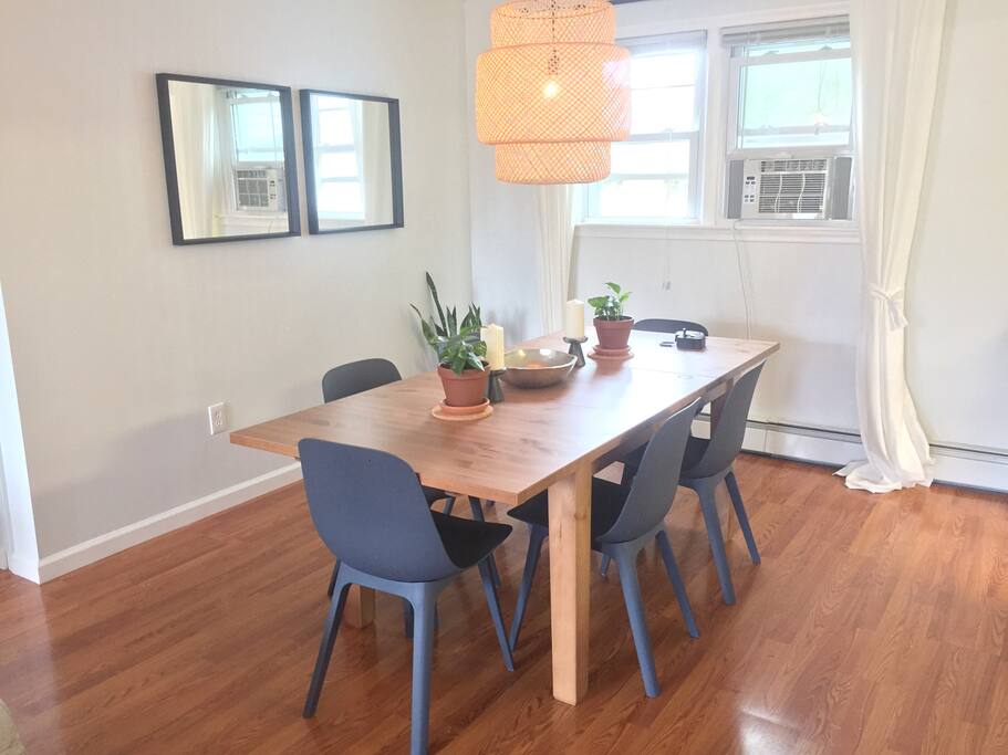Dining table fits 6 comfortably, 8 or more can squeeze with extra chairs (provided)