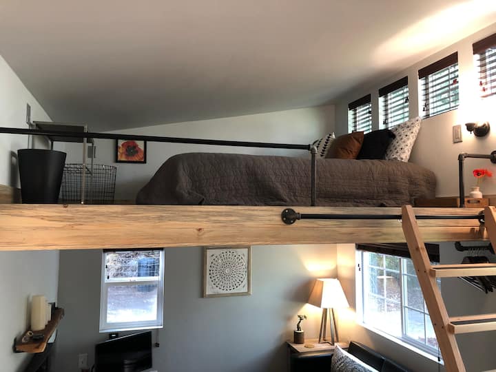Sturdy ladder up to loft with cozy queen bed with organic sheets. Watch your head at the foot of the bed, the ceiling is low.