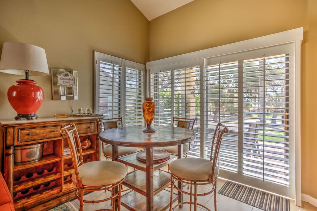 four seat dining with plantation shutters and view of fairway.