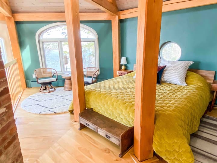 The king bed in the loft bedroom upstairs. There are expansive views from the bed down the Saint George to open ocean. 