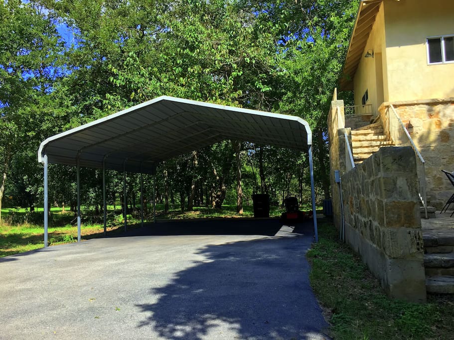 A carport is located right next to the house, and extra space for vehicles is also available in the driveway