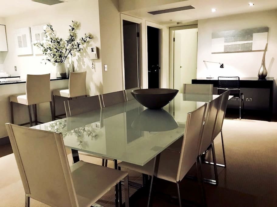 Inside dining table sets 8, breakfast bar seats 2 and the balcony outside table seats 4.