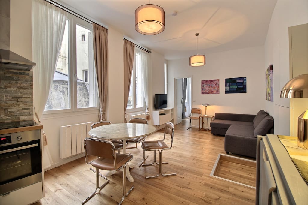 Living room with sofa, TV and dining area