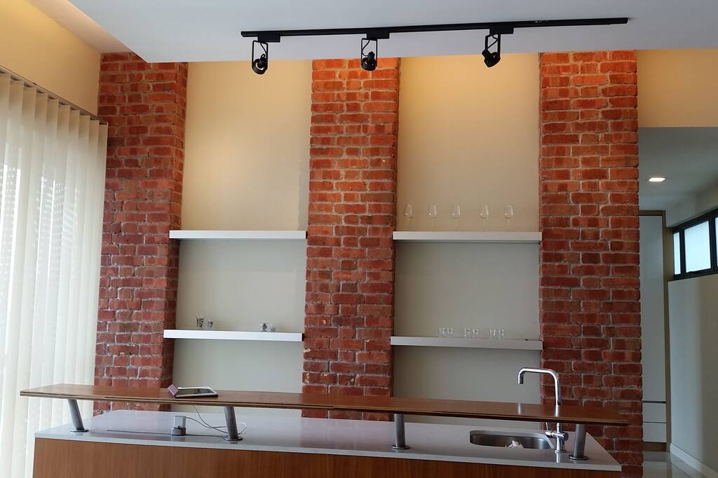 The stylish & modern Island / Bar Counter.
The bar counter top is made of Granite Marble and Wood; and a stainless steel sink & faucet; and additional kitchen drawers/organizers.