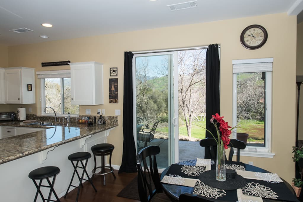 Dining area looks out onto patio with seating for 6
