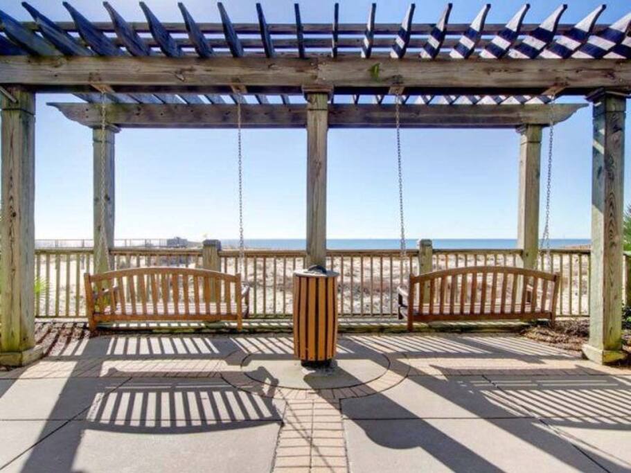 Several sets of swings facing the water. We love a morning cup of coffee here, before our morning walk on the beach.