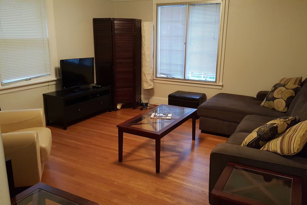 The cozy living room has a TV and games in the stand for your entertainment on rainy nights.