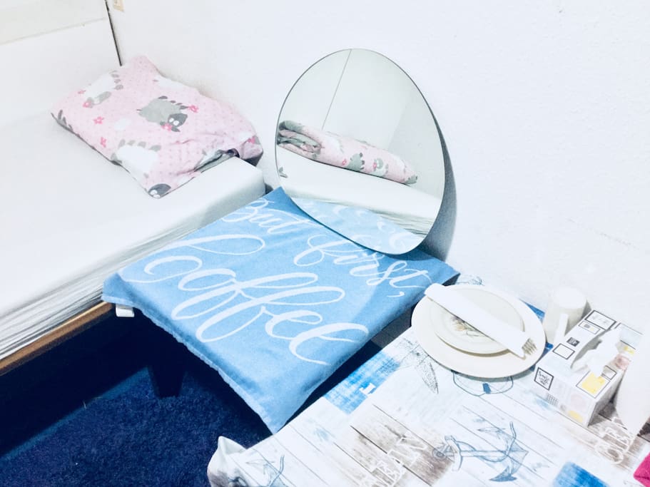 A mirror and cutlery items.