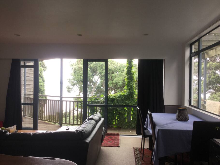 Living room and dining table with deck access.