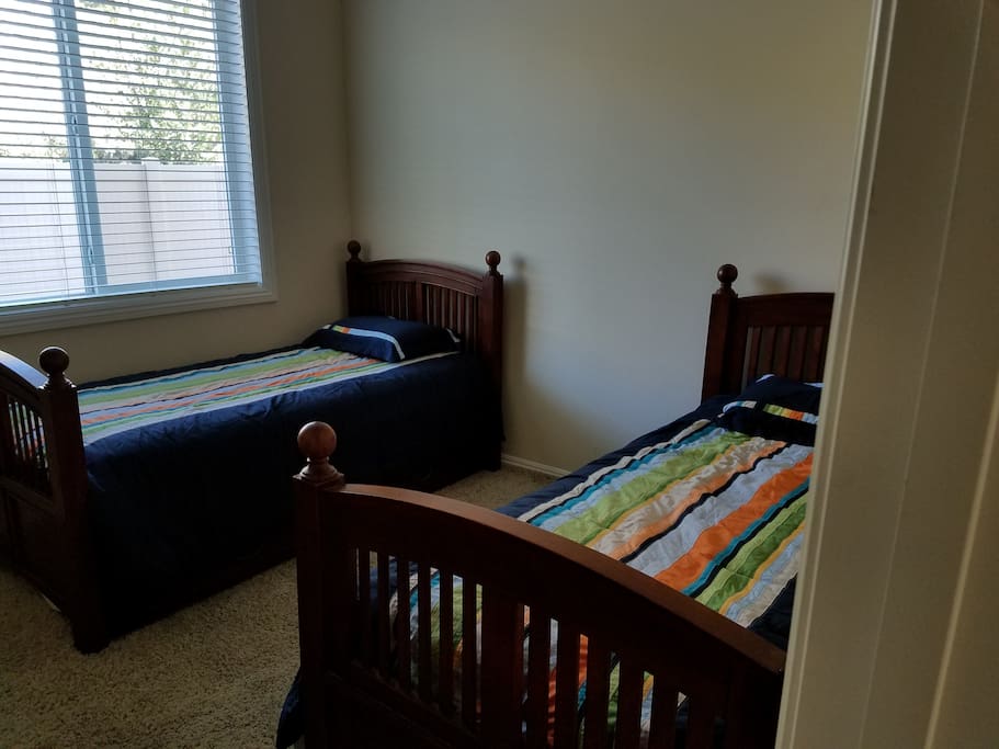 Two bunk beds with a trundle bed under one.