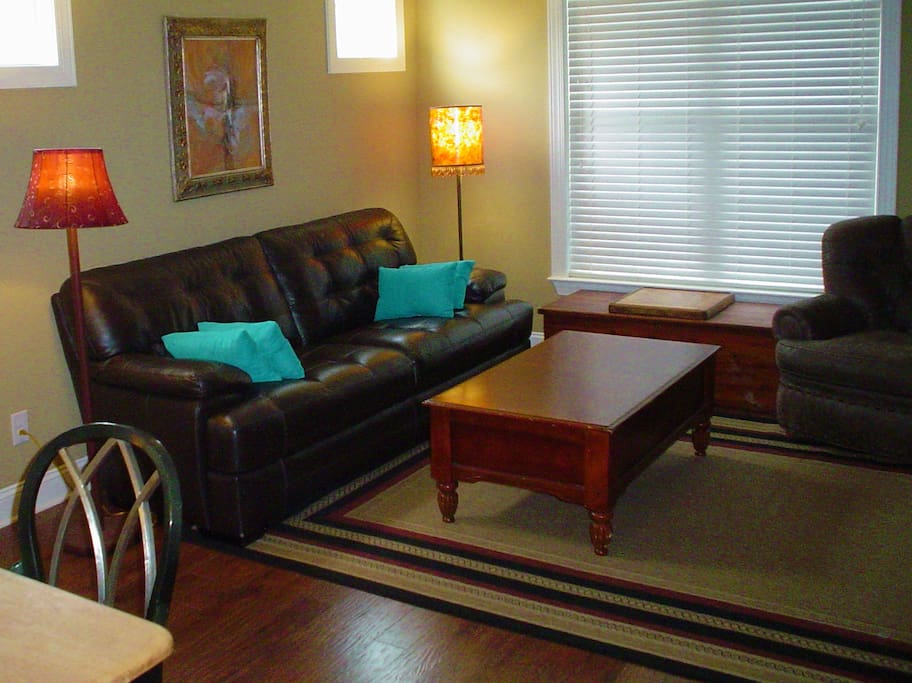 Living room features large leather sofa and easy chair