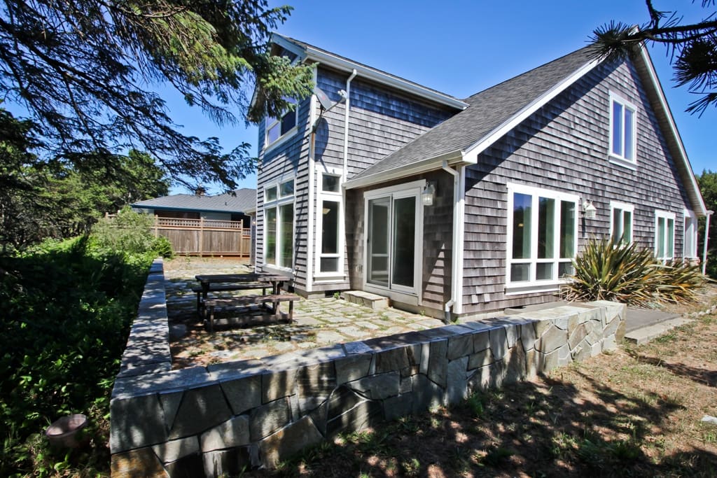 Large side stone patio with picnic table, two wrought iron tables for 4 each, charcoal BBQ and beautiful golf course views
