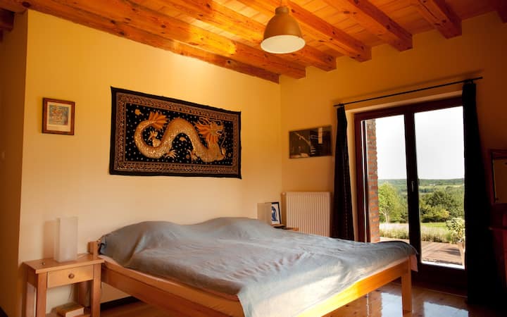 One of the bedrooms on the ground floor with a king size bed (and patio door)