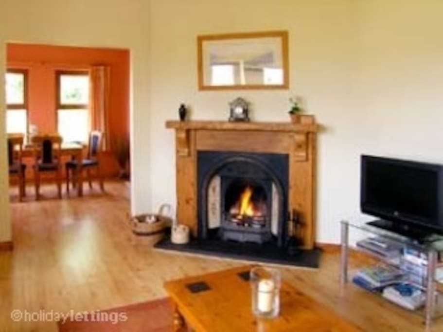 Fireplace with coal fire, 3 & 2 seater settees