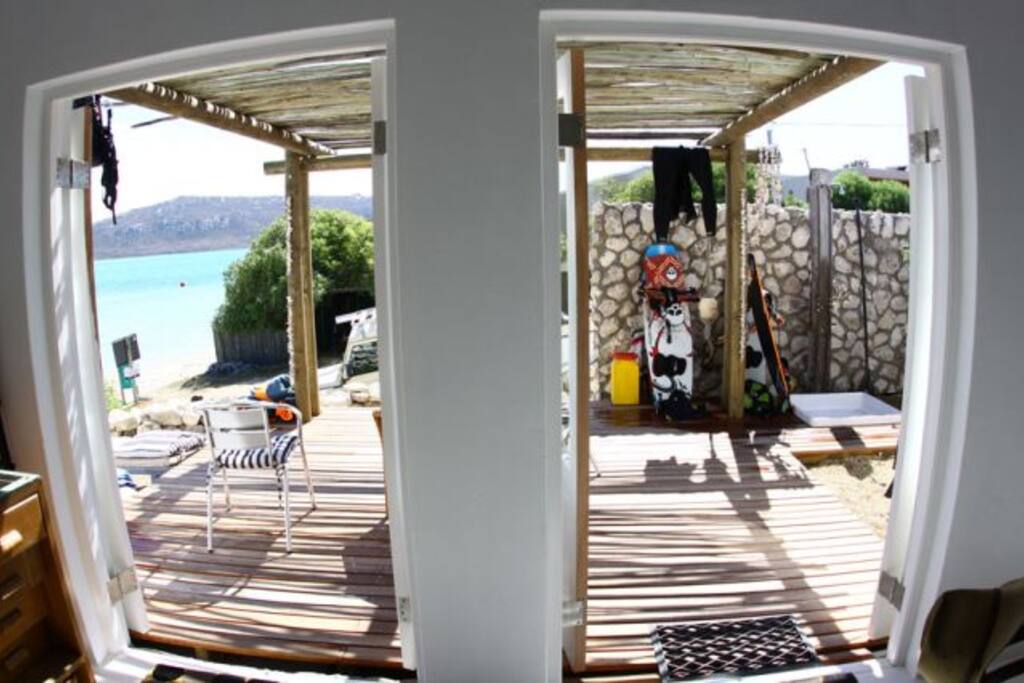 The dining area opens out onto a sunny deck with hot and cold outdorr shower to rinse off when you come in from the beach