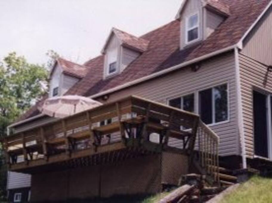 Rear view of cottage with deck and BBQ