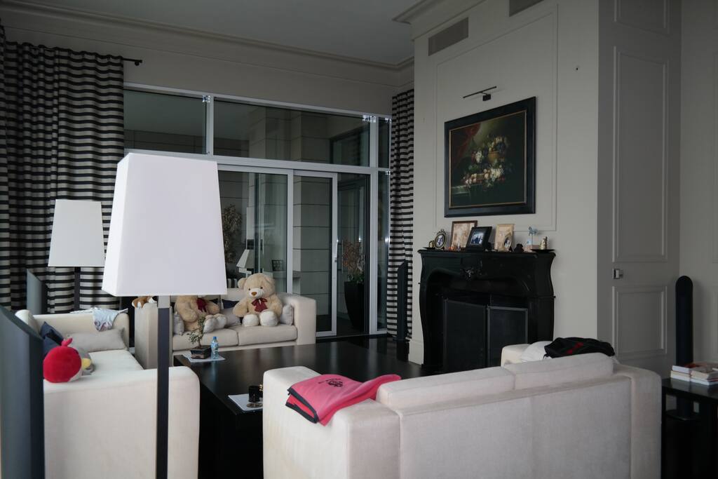 Yet another view of the main living room. It has a fireplace.