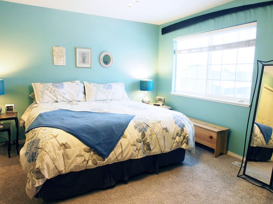 The beautiful master bedroom is filled with natural light and plenty of space.